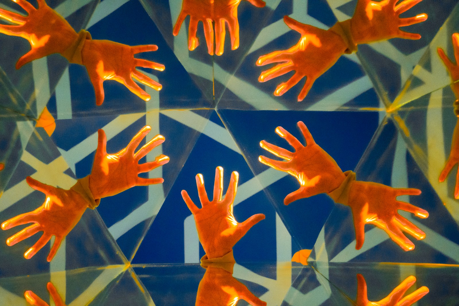 geometry, hands, pattern, playfulness, reflections, symmetry, warm light