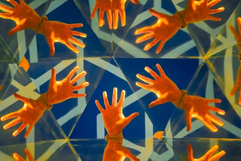geometry, hands, pattern, playfulness, reflections, symmetry, warm light